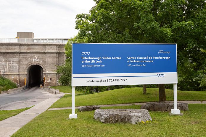 Signage for the new Peterborough Visitor Centre at 353 Hunter Street East just west of the tunnel under the Peterborough Lift Lock. (Photo: Jordan Lyall / kawarthaNOW)
