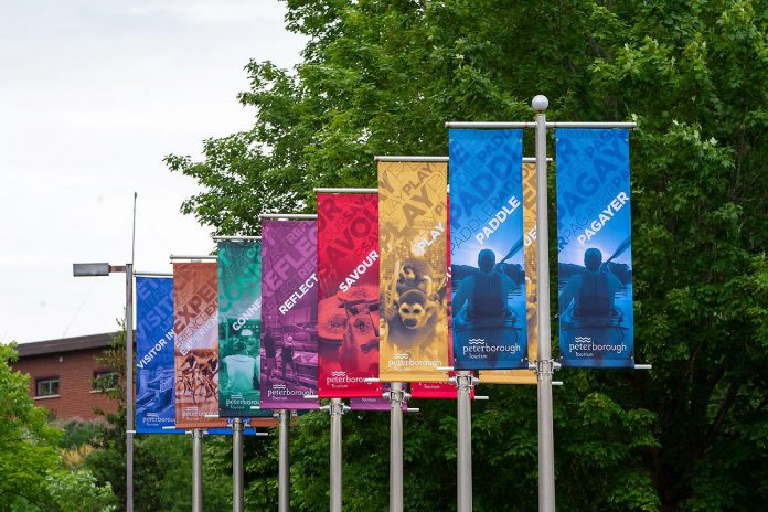 Peterborough Tourism branded banners hanging outside the new Peterborough Visitor Centre at 353 Hunter Street East. (Photo: Jordan Lyall / kawarthaNOW)