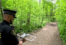 An officer with Elgin County Ontario Provincial Police (OPP) demonstrates the tracking technology used in the Project Lifesaver program, which helps searchers quickly locate people with cognitive disorders who wander. Through a collaborative partnership between local emergency services and community organizations, the internationally recognized program is coming to Kawartha Lakes in summer 2026. (Photo: OPP)