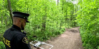 An officer with Elgin County Ontario Provincial Police (OPP) demonstrates the tracking technology used in the Project Lifesaver program, which helps searchers quickly locate people with cognitive disorders who wander. Through a collaborative partnership between local emergency services and community organizations, the internationally recognized program is coming to Kawartha Lakes in summer 2026. (Photo: OPP)