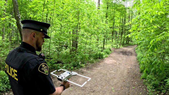 An officer with Elgin County Ontario Provincial Police (OPP) demonstrates the tracking technology used in the Project Lifesaver program, which helps searchers quickly locate people with cognitive disorders who wander. Through a collaborative partnership between local emergency services and community organizations, the internationally recognized program is coming to Kawartha Lakes in summer 2026. (Photo: OPP) An officer with Elgin County Ontario Provincial Police (OPP) demonstrates the tracking technology used in the Project Lifesaver program, which helps searchers quickly locate people with cognitive disorders who wander. Through a collaborative partnership between local emergency services and community organizations, the internationally recognized program is coming to Kawartha Lakes in summer 2026. (Photo: OPP)