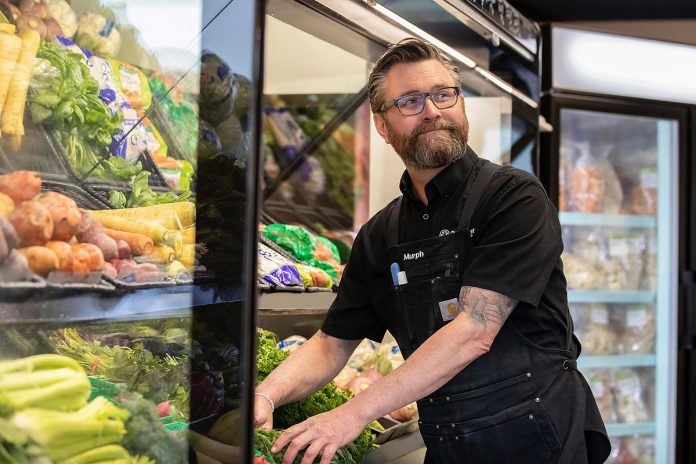 At the age of 50, Young's Point resident Darren Murphy made the leap from a 25-year career working in media, including as publisher of the Peterborough Examiner, to becoming a small business owner by purchasing The Market in Lakefield. Murphy says connecting with customers and sharing cooking tips is one of his favourite parts of the job. (Photo: Jordan Lyall Photography)