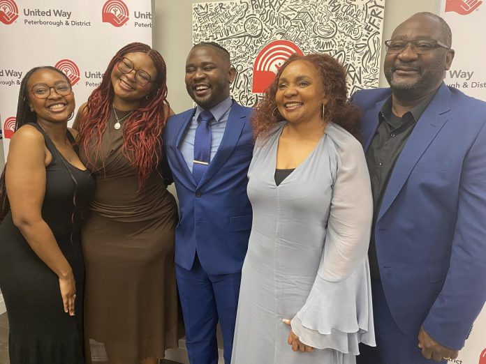 The United Way Peterborough and District's incoming CEO Jason Seguya (middle) with his family, sisters Phillipa and Fiona Sekalala and parents Sarah and Phares Sekalala, during an announcement at the United Way's office on June 18, 2026. (Photo: Paul Rellinger / kawarthaNOW)
