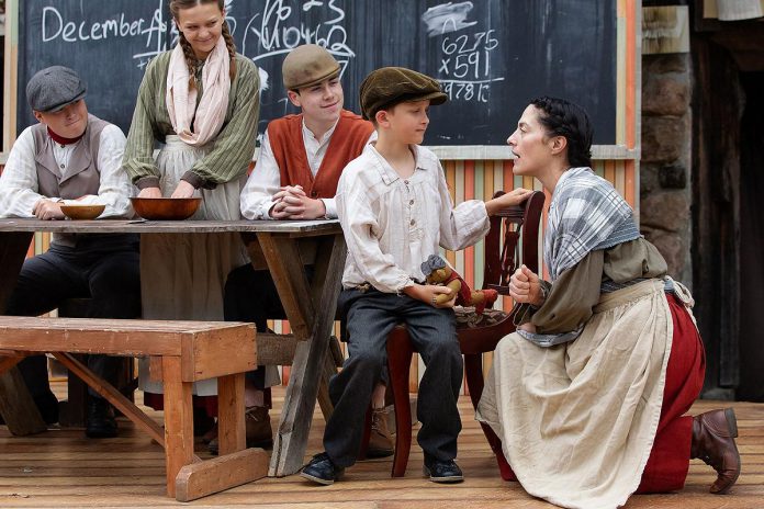 Actor Lindsay Wilson talks to Jasper Chesser in a scene from "Wild Irish Geese" as (left to right) Padrick Wilson, Indigo Chesser, and Darragh O'Connell look on during a media day event at 4th Line Theatre in Millbrook on July 22, 2026. Megan Murphy's play about the Peter Robinson emigration returns to the Winslow Farm from August 4 to 29 after its sold-out world premiere last summer. (Photo: Jordan Lyall / kawarthaNOW)