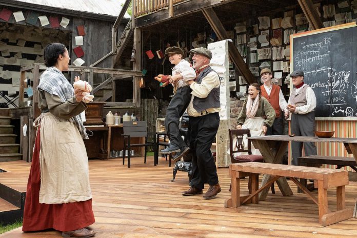 Actor Paul Crough lifts Jasper Chesser in a scene from "Wild Irish Geese" with (left to right) Lindsay Wilson, Indigo Chesser, Darragh O'Connell, and Padrick Wilson during a media day event at 4th Line Theatre in Millbrook on July 22, 2026. Megan Murphy's play about the Peter Robinson emigration returns to the Winslow Farm from August 4 to 29 after its sold-out world premiere last summer. (Photo: Jordan Lyall / kawarthaNOW)