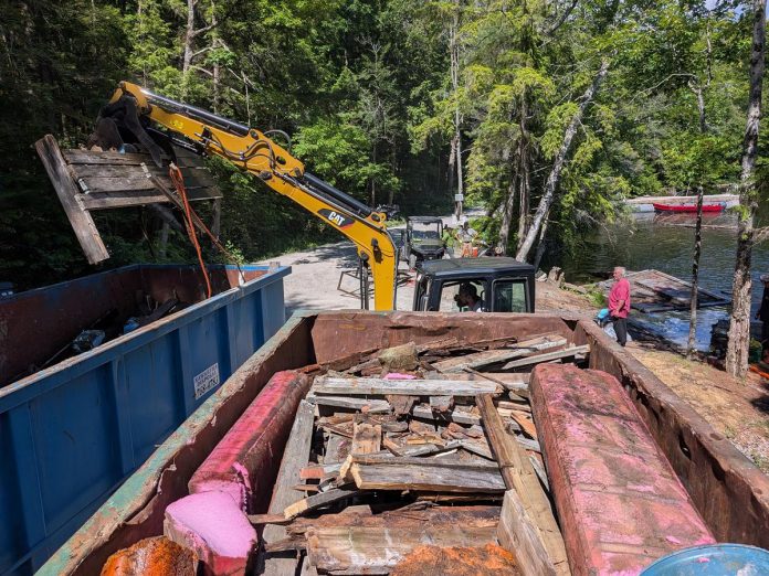 Although community volunteers are donating their time and efforts to collect, extract, and dispose of abandoned docks and other waste from the Catchacoma-Mississagua lakes system as part the Abandoned Docks Initiative, there are costs associated with renting machinery and disposal bins as well as landfill tipping fees. Although the initiative's partners received a $14,400 community grant from the Municipality of Trent Lakes, the cost of the cleanup so far is $20,000 and organizers have launched a $20,000 GoFundMe to cover the $5,600 shortfall and additional costs to remove even more abandoned docks. (Photo courtesy of Abandoned Dock Initiative)  