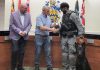 Cobourg police service board chair Adam Bureau (left) and retired sergeant Don Missen, who led the Cobourg police's former canine unit from 1997 to 2003, presented Constable Amrit Gill and German shepherd Atos with the K-9 badge at a ceremony during the police service board's meeting in council chambers at Victoria Hall on July 28, 2026. (Photo courtesy of Cobourg Police Service)