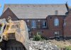 A view of the west side of Mark Street United Church at 90 Hunter Street East in Peterborough's East City as demolition continues of the church's former Christian Education Centre, the site of TVM Group's new 17-storey high-rise apartment building, on July 23, 2026. (Photo: Bruce Head / kawarthaNOW)