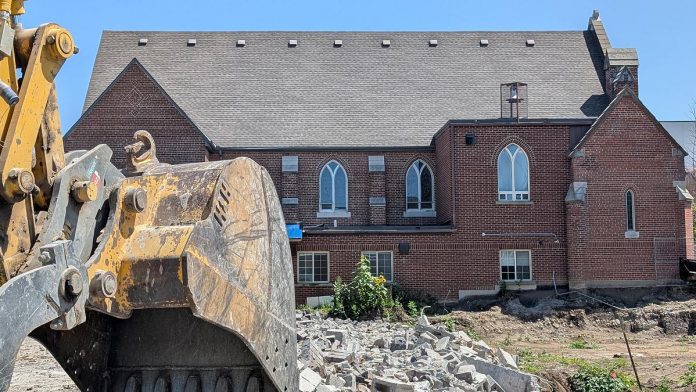 A view of the west side of Mark Street United Church at 90 Hunter Street East in Peterborough's East City as demolition continues of the church's former Christian Education Centre, the site of TVM Group's new 17-storey high-rise apartment building, on July 23, 2026. (Photo: Bruce Head / kawarthaNOW) A view of the west side of Mark Street United Church at 90 Hunter Street East in Peterborough's East City as demolition continues of the church's former Christian Education Centre, the site of TVM Group's new 17-storey high-rise apartment building, on July 23, 2026. (Photo: Bruce Head / kawarthaNOW)