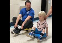 Five Counties Children's Centre CEO Scott Pepin races client Hamish down the hall after he completed one of his recent treatment sessions at the Peterborough-based children's treatment centre. (Photo courtesy of Five Counties Children's Centre)