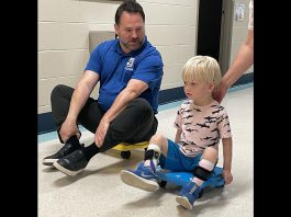 Five Counties Children's Centre CEO Scott Pepin races client Hamish down the hall after he completed one of his recent treatment sessions at the Peterborough-based children's treatment centre. (Photo courtesy of Five Counties Children's Centre)