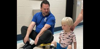 Five Counties Children's Centre CEO Scott Pepin races client Hamish down the hall after he completed one of his recent treatment sessions at the Peterborough-based children's treatment centre. (Photo courtesy of Five Counties Children's Centre)