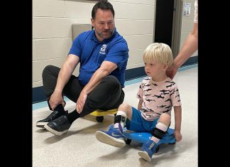 Five Counties Children's Centre CEO Scott Pepin races client Hamish down the hall after he completed one of his recent treatment sessions at the Peterborough-based children's treatment centre. (Photo courtesy of Five Counties Children's Centre)