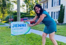 Brazen daylight theft of election lawn signs leaves Peterborough councillor candidate upset and disappointed Jenni Cathcart, one of four candidates vying for two Town Ward seats on Peterborough city council in the October municipal election, placing an election lawn sign. The first-time candidate tells kawarthaNOW that three of her election signs, including one on the lawn of her own Homewood Avenue home, were taken by someone in the middle of the day on July 20, 2026. (Photo courtesy of Jenni Cathcart campaign)