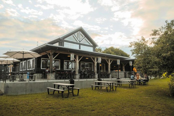 The large property and dog-friendly covered patio at 100 Acre Brewing Co. in Peterborough makes a stunning natural space for family and friends to gather year-round and enjoy the creatively driven craft beer brewed and served on site. The brewery was developed with the goal of encouraging diners to not rush, but rather enjoy the 100-acre family property where brewer Bentley Vass grew up with his siblings. (Photo courtesy of 100 Acre Brewing Co.)