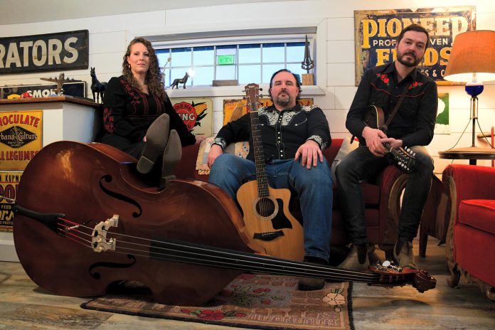 Southwestern Ontario folk/roots trio Cabin Fever (Jessica McKay on upright bass and vocals, Kyle Faulkner on guitar and vocals, and Colin Jolly on mandolin) perform their blend of Canadian Americana, folk, and bluegrass music with captivating storytelling at the Dominion Hotel in Minden on Saturday night. (Photo: Will Ronholm Photography)