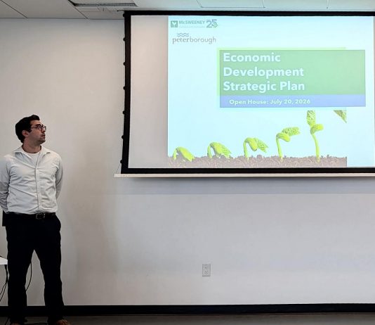 Kevin McPhillips of McSweeney & Associates, the consulting firm retained by the City of Peterborough to facilitiate the creation of the city's new five-year economic development strategic plan, waits to make a presentation during a community open house at Miskin Law Community Complex on July 20, 2026. (Photo: Bethan Bates / kawarthaNOW)