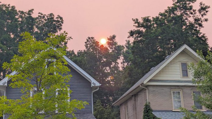 The evening sky above Peterborough's East City on July 14, 2026 as a result of smoke from forest fires in northwestern Ontario. (Photo: Bruce Head / kawarthaNOW)