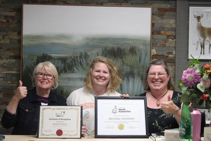 Peterborough County warden Bonnie Clark (left) and North Kawartha mayor Carolyn Amyotte (right) presented certificates to Shoreline Furniture Co. owner Jessica Tucker recognizing the 10th anniversary of her Apsley-based business. (Photo: Shoreline Furniture Co.)