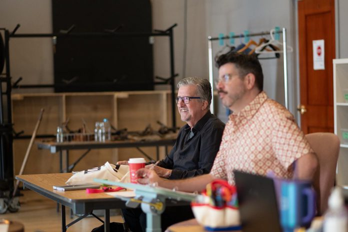 Playwright Dave Carley (left) with director Rob Kempson during a rehearsal of Carley's adaptation of Farley Mowat's Second World War memoir "And No Birds Sang", which premieres at the Capitol Theatre's Sculthorpe Theatre in Port Hope, running for 27 performances from August 14 to September 6, 2026. Originally staged as 10-minute excerpt for Port Hope's 10-Minute Play Series, Carley developed the full-length play in the Capitol Theatre's Creators' Unit in 2024. (Photo: Sam Moffatt)
