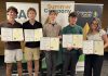 Six Peterborough-area student entrepreneurs graduate from Summer Company program Rutger Huntley, Aiden Budd, Zander Bromley, Caleb Galbraith, and Rielle MacDougall are five of the six Peterborough-area student entreprenuers who graduated from the provincially funded Summer Company program, administered locally by Community Futures Peterborough's Business Advisory Centre. Not pictured is Emma George-Peters. The young entrepreneurs participated in a graduation ceremony at Venture North in downtown Peterborough on August 26, 2026 along with a tradeshow showcasing the businesses they launched and operated throughout the summer. (Photo courtesy of Community Futures Peterborough)