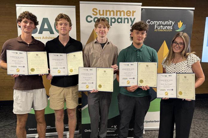 Rutger Huntley, Aiden Budd, Zander Bromley, Caleb Galbraith, and Rielle MacDougall are five of the six Peterborough-area student entreprenuers who graduated from the provincially funded Summer Company program, administered locally by Community Futures Peterborough's Business Advisory Centre. Not pictured is Emma George-Peters. The young entrepreneurs participated in a graduation ceremony at Venture North in downtown Peterborough on August 26, 2026 along with a tradeshow showcasing the businesses they launched and operated throughout the summer. (Photo courtesy of Community Futures Peterborough)