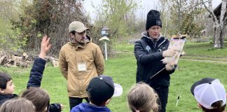 Jakob Payne and Janelle Wiens, two Trent University learning garden teacher candidates, deliver a "Pollen Power" school program to a Grade 1 class at Ecology Park in Peterborough. GreenUP's education program offers a variety of hands-on, curriculum and experiential-based field trip options for students in kindergarten up to Grade 7. (Photo: Melanie Ellison / GreenUP)