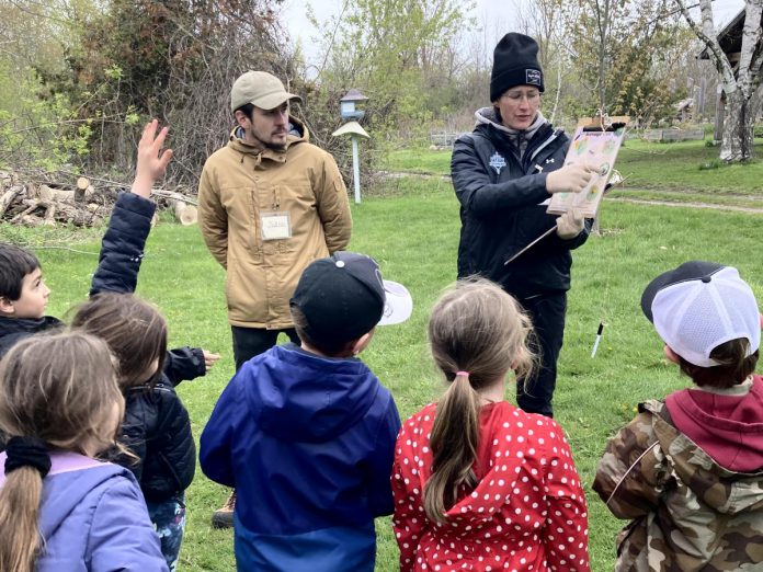 Jakob Payne and Janelle Wiens, two Trent University learning garden teacher candidates, deliver a "Pollen Power" school program to a Grade 1 class at Ecology Park in Peterborough. GreenUP's education program offers a variety of hands-on, curriculum and experiential-based field trip options for students in kindergarten up to Grade 7. (Photo: Melanie Ellison / GreenUP) Jakob Payne and Janelle Wiens, two Trent University learning garden teacher candidates, deliver a "Pollen Power" school program to a Grade 1 class at Ecology Park in Peterborough. GreenUP's education program offers a variety of hands-on, curriculum and experiential-based field trip options for students in kindergarten up to Grade 7. (Photo: Melanie Ellison / GreenUP)