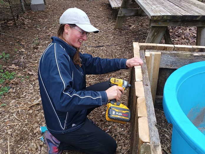 Janelle Wiens participated in the 2026 learning garden, an alternative settings placement for Trent University teacher candidates in collaboration with GreenUP. The program offered new teachers experience with outdoor education and invited them to slow down and find nature's rhythms so they are more comfortable teaching ecological literacy to the next generation. Pictured is Janelle working on a pool surround for aquatic plants at GreenUP Ecology Park Native Plant Nursery during her placement. (Photo: Christina Balint / GreenUP)