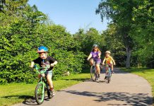 Laura, 8, and Adam, 6, are pedalling all over Peterborough with their mom Jennifer this summer as part of GreenUP's Summer Ride Club. "It's a really good habit to ... use your body to get places instead of just always driving," says Jennifer. "Building that confidence now will help them when they're older and they can be more reliant on themselves to get places." (Photo: Brett Throop / GreenUP)