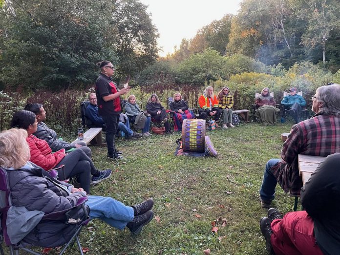 Coldwater Ojibwe artist, entrepreneur, and healer Jared BigCanoe shares Indigenous stories, songs, drumming, and demonstrations during a campfire event held during the 2025 Hike Haliburton festival. The event, along with another hosted by BigCanoe, helped the annual festival earn an Impact Award from Festivals and Events Ontario. BigCanoe will once again be hosting the campfire during the 2026 festival on Friday, September 18 at 7 p.m. at the Haliburton Forest and Wild Life Reserve. (Photo courtesy of Haliburton County)