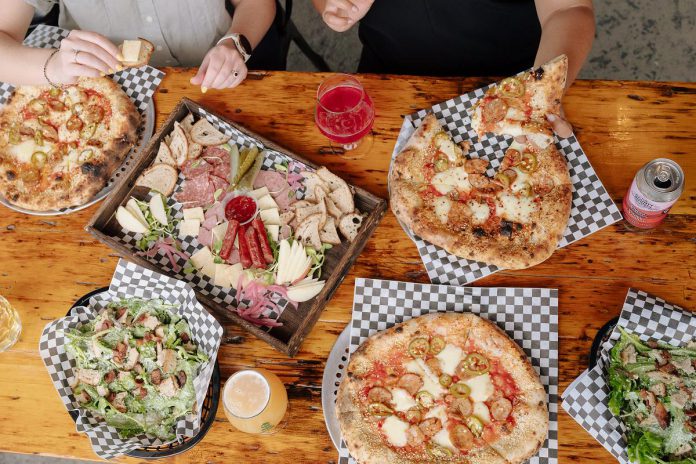 At 100 Acre Brewing Company in Peterborough, you can dine on organic sourdough wood-fired pizzas from Lowlands Fire Foods. These pizzas are made from dough with Red Fife and 100 per cent Empire Co-op mozzarella, a high-quality cheese from Campbellford. Executive chef Jamie Kohls brings fine dining experience to the brewery and launches new and noteworthy seasonal pizzas every two to three weeks. (Photo courtesy of Lowlands Fire Foods)
