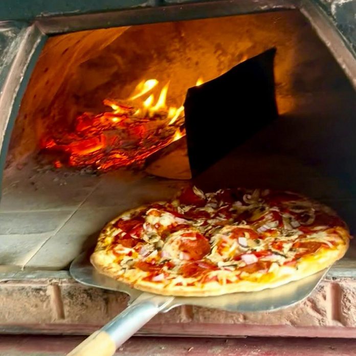 At Kawartha Country Wines, Canadian dough, sauces, and vegetables are sourced to create quality wood-fired pizza that can be curated to the customer's liking. Kawartha Country Wines promises celiac-safe pizza options with gluten-free crust where there is no risk of cross-contamination. (Photo courtesy of Kawartha Country Wines)