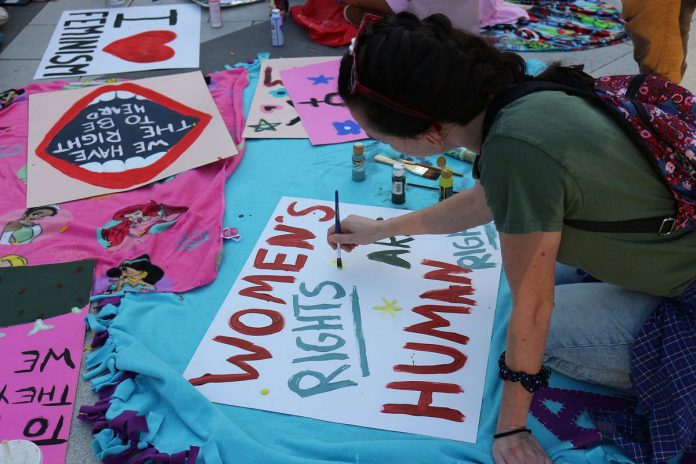 As at previous "Take Back the Night" events, such as the 2025 event on September 17 pictured here, the Kawartha Sexual Assault Centre will be providing poster- and sign-making supplies to enable people who do not have the opportunity or means to bring their own signs to the rally to be fully involved. The 2026 event runs from 5 to 9 p.m. on Thursday, September 17 outside in the Peterborough Square Courtyard. (Photo: Julia Lawrence)