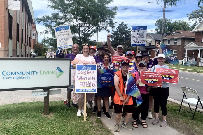 OPSEU Local 358 president Jessica Bushey (front left) with developmental services workers and supporters in front of the Community Living Trent Highlands office on Aylmer Street in Peterborough on June 12, 2026. (Photo: Bethan Bates / kawarthaNOW)