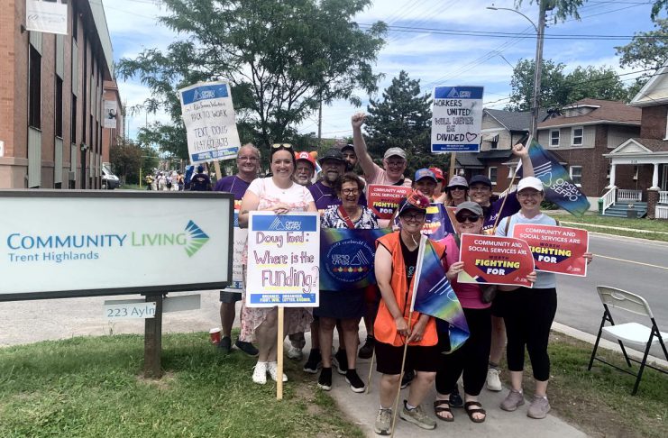 OPSEU Local 358 president Jessica Bushey (front left) with developmental services workers and supporters in front of the Community Living Trent Highlands office on Aylmer Street in Peterborough on June 12, 2026. (Photo: Bethan Bates / kawarthaNOW)