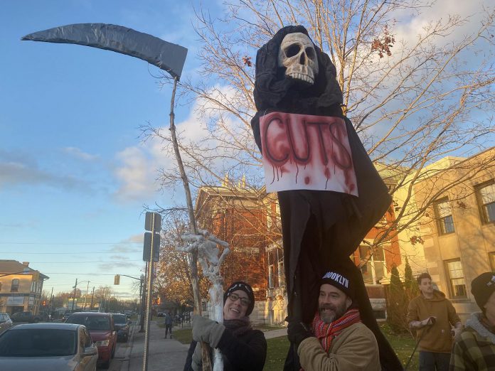 Supporters of local arts and social services organizations gathered outside Peterborough City Hall on November 12, 2024 to protest a proposed 25 per cent across-the-board cut in the City of Peterborough's 2025 draft budget to grants to community organizations. Following strong community opposition, city council ultimately voted against the cuts. (Photo: Paul Rellinger / kawarthaNOW)