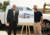 Millwright Regional Council director of public affairs and strategic initiatives Chris Sutton and Northumberland-Peterborough South MPP and Minister of Labour, Immigration, Training and Skills Development David Piccini alongside a rendering of the new skilled trades training centre under construction in the Port Hope Business Park during an announcement on August 20, 2026 of $9.8 million in provincial funding for the facility led by UBC Millwright Local 2309. (Photo: Office of David Piccini)