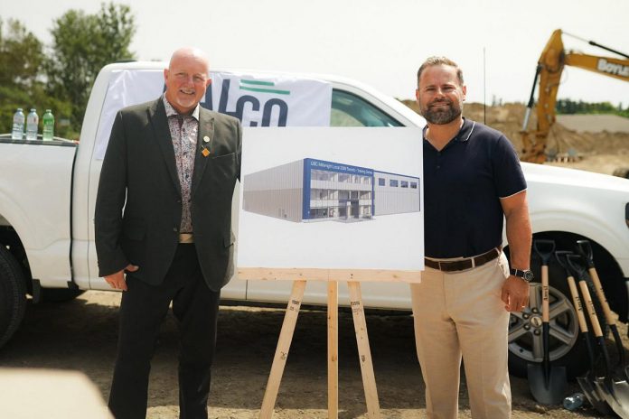 Millwright Regional Council director of public affairs and strategic initiatives Chris Sutton and Northumberland-Peterborough South MPP and Minister of Labour, Immigration, Training and Skills Development David Piccini alongside a rendering of the new skilled trades training centre under construction in the Port Hope Business Park during an announcement on August 20, 2026 of $9.8 million in provincial funding for the facility led by UBC Millwright Local 2309. (Photo: Office of David Piccini)