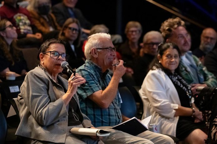 kawarthaNOW publisher and CEO Jeannine Taylor asks a question of the candidates during ArtsVote Peterborough 2026, hosted by the Electric City Culture Council (EC3) on Wednesday, September 23 at Market Hall Performing Arts Centre in downtown Peterborough, with kawarthaNOW writer Paul Rellinger beside her. (Photo: Jordan Lyall / kawarthaNOW)