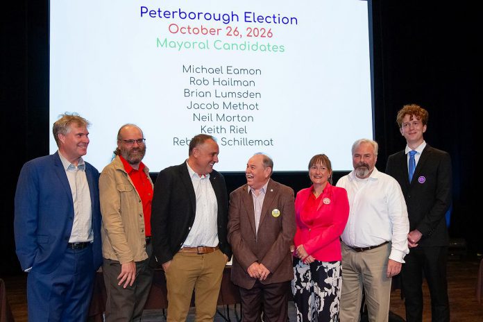 The seven candidates vying to become Peterborough's next mayor — Michael Eamon, Rob Hailman, Neil Morton, Keith Riel, Rebecca Schillemat, Brian Lumsden, and Jacob Méthot — on stage at Market Hall Performing Arts Centre for ArtsVote Peterborough 2026, hosted by the Electric City Culture Council (EC3) on Wednesday, September 23. (Photo: Jordan Lyall / kawarthaNOW)