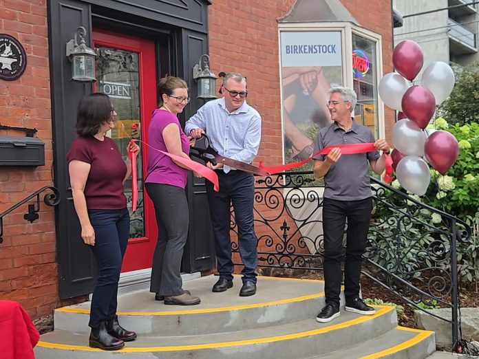 New owners Theresa Thibadeau and Mark Walsh cut the ribbon at the entrance to Grady's Feet Essentials at 231 King Street in downtown Peterborough as retiring owners Kelli and Tony Grady look on during a ceremony on September 1, 2026. (Photo: Grady's Feet Essentials)