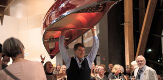 Bill Swift, owner and manager of Swift Canoe & Kayak, carries a canoe that sold for $5,000 during the live auction at the 2025 Lakeside Gala at The Canadian Canoe Museum in Peterborough. The company will once again be donating a canoe for the 2026 Lakeside Gala on Saturday, October 3, one of many donated items that will be available for bidding during the live and silent auctions to raise funds supporting the Museum's core programming. (Photo courtesy of The Canadian Canoe Museum)