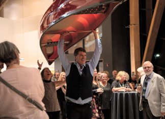 Bill Swift, owner and manager of Swift Canoe & Kayak, carries a canoe that sold for $5,000 during the live auction at the 2025 Lakeside Gala at The Canadian Canoe Museum in Peterborough. The company will once again be donating a canoe for the 2026 Lakeside Gala on Saturday, October 3, one of many donated items that will be available for bidding during the live and silent auctions to raise funds supporting the Museum's core programming. (Photo courtesy of The Canadian Canoe Museum)