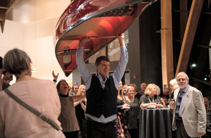Bill Swift, owner and manager of Swift Canoe & Kayak, carries a canoe that sold for $5,000 during the live auction at the 2025 Lakeside Gala at The Canadian Canoe Museum in Peterborough. The company will once again be donating a canoe for the 2026 Lakeside Gala on Saturday, October 3, one of many donated items that will be available for bidding during the live and silent auctions to raise funds supporting the Museum's core programming. (Photo courtesy of The Canadian Canoe Museum)