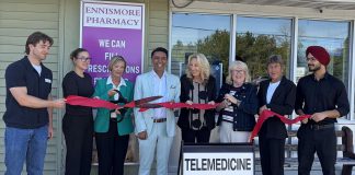 With Ennismore Pharmacy owner and pharmacist Mehul Pathak standing to her left, Selwyn Township mayor Sherry Senis cuts the ribbon to officially open the pharmacy's new telemedicine clinic. The clinic offers OHIP-covered virtual consultations with licensed healthcare professionals for assessments, treatment, prescription services, referrals, and follow-up care. (Photo courtesy of Ennismore Pharmacy)