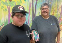 11-year-old Wyatt Robertson of Cobourg, a client of Five Counties Children's Centre, with happy customer Yvette Virgin, who holds an articulated animal that Wyatt made through his fledging 3D printing business called Prints Charming. (Photo courtesy of Five Counties Children's Centre)