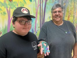 11-year-old Wyatt Robertson of Cobourg, a client of Five Counties Children's Centre, with happy customer Yvette Virgin, who holds an articulated animal that Wyatt made through his fledging 3D printing business called Prints Charming. (Photo courtesy of Five Counties Children's Centre)