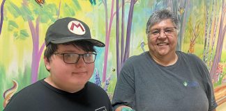 11-year-old Wyatt Robertson of Cobourg, a client of Five Counties Children's Centre, with happy customer Yvette Virgin, who holds an articulated animal that Wyatt made through his fledging 3D printing business called Prints Charming. (Photo courtesy of Five Counties Children's Centre)