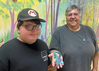 11-year-old Wyatt Robertson of Cobourg, a client of Five Counties Children's Centre, with happy customer Yvette Virgin, who holds an articulated animal that Wyatt made through his fledging 3D printing business called Prints Charming. (Photo courtesy of Five Counties Children's Centre)